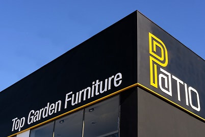 PATIO top garden furniture store in Marbella, building corner with corporate signals